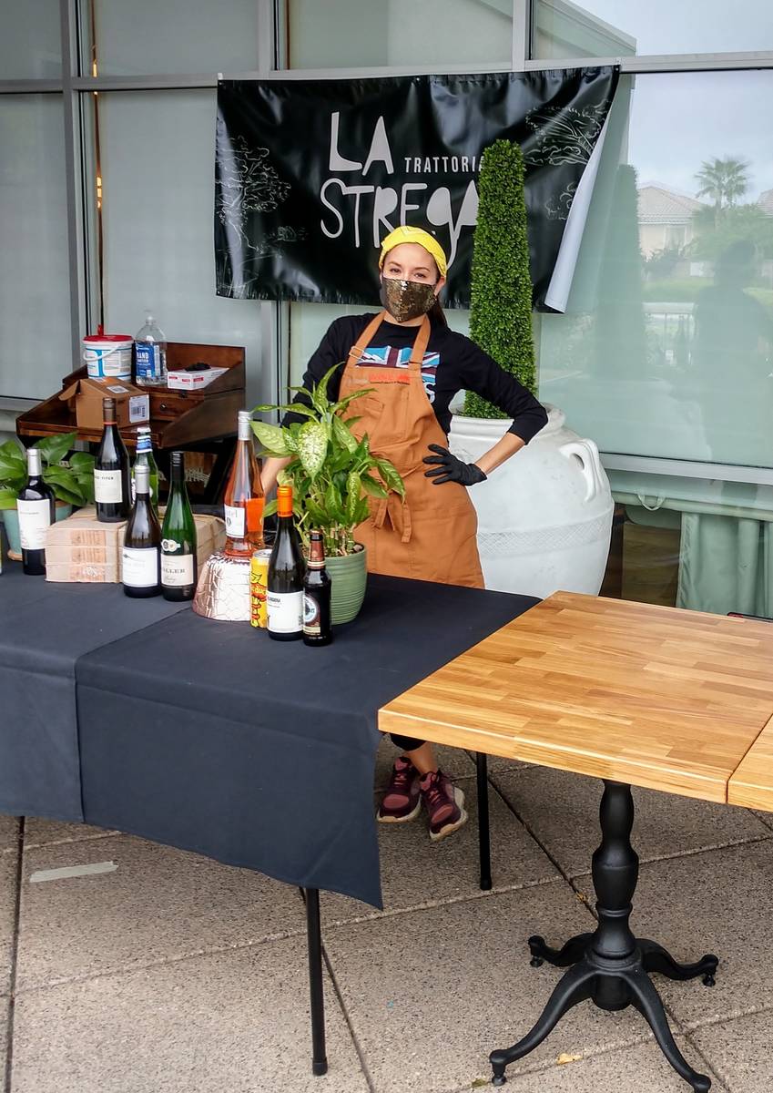 An employee of La Strega Trattoria mans the restaurant's curbside-pickup station. (La Strega)