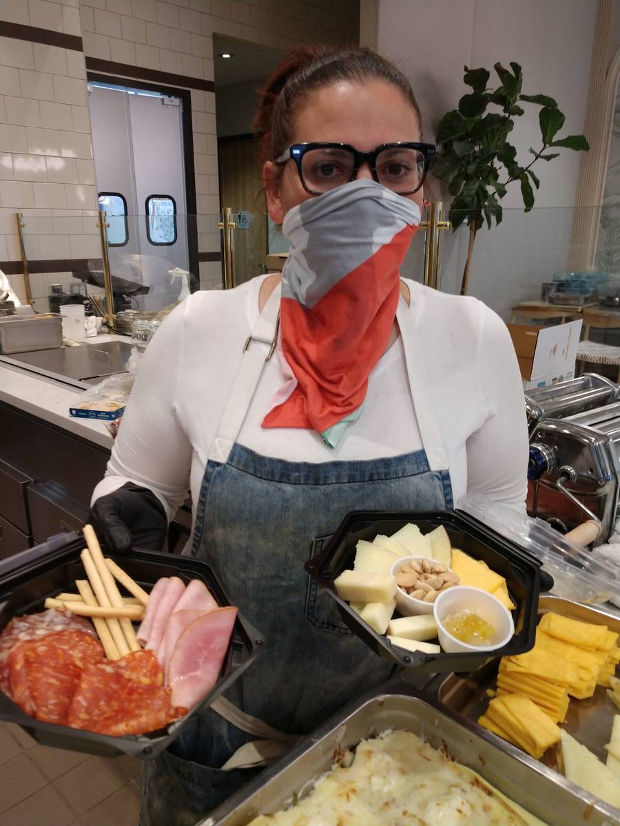 A worker at La Strega wears a face covering while handling food. (La Strega)