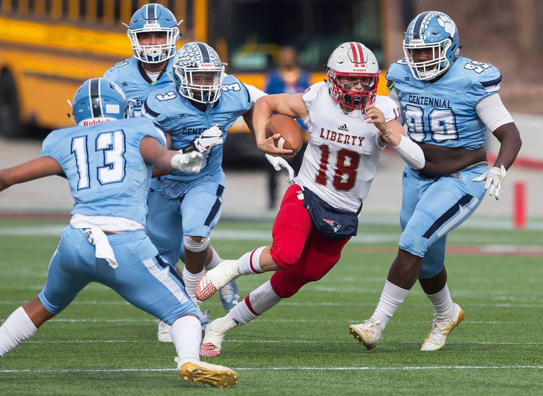 Liberty junior quarterback Daniel Britt (18) cuts up field past Centennial senior Donte Washin ...