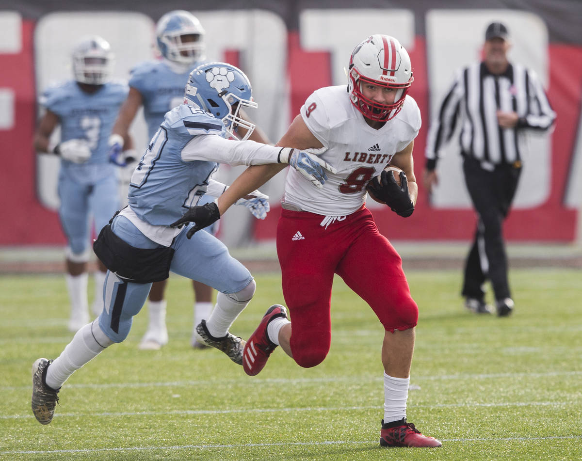 Liberty junior tight end Moliki Matavao (9) breaks into the open field past Centennial junior J ...