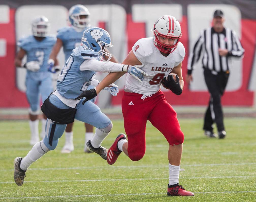 Liberty junior tight end Moliki Matavao (9) breaks into the open field past Centennial junior J ...