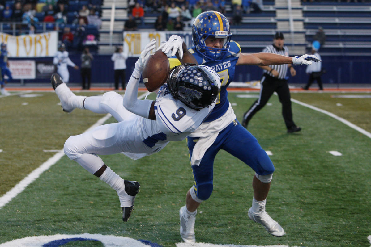 Moapa Valley defensive back Cole Mulcock breaks up a pass intended for Desert Pines wide receiv ...