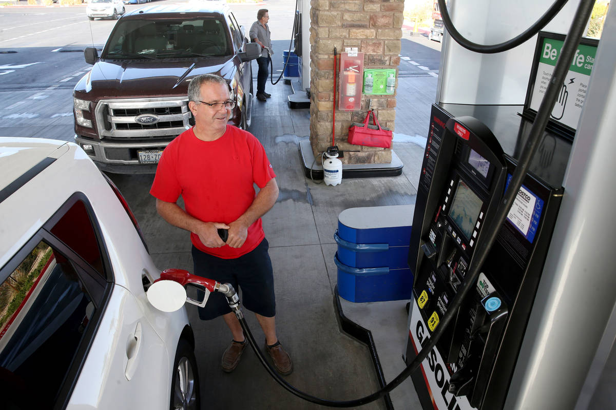 Mark Blanco of Las Vegas fills his gas tank at Costco near the intersection of North Decat ...