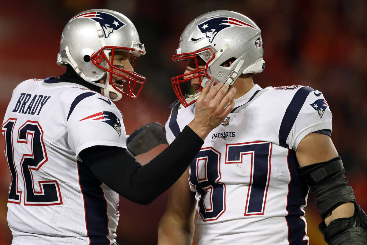 New England Patriots quarterback Tom Brady (12) celebrates with tight end Rob Gronkowski (87) d ...