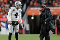 Raiders quarterback Derek Carr (4) and head coach Jon Gruden discuss a play call during the sec ...