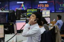 A currency trader talks on the phone at the foreign exchange dealing room of the KEB Hana Bank ...