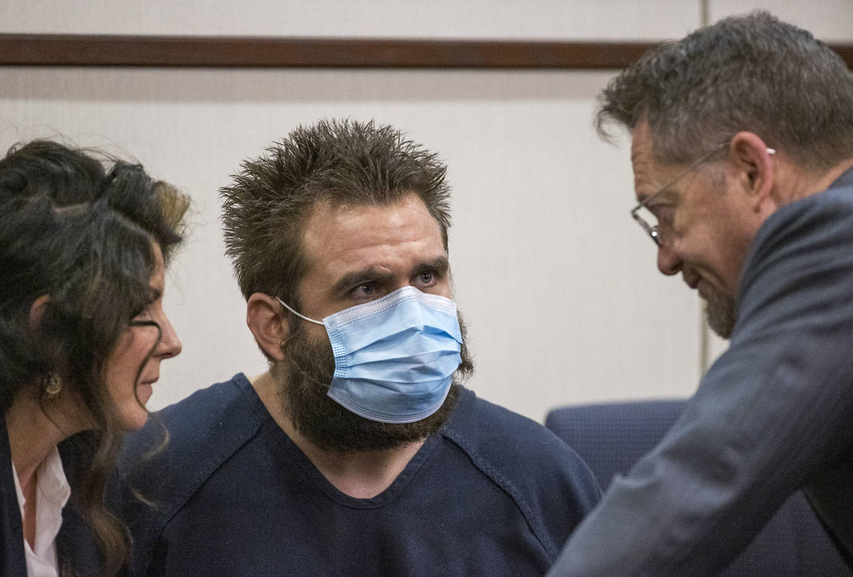 Joshua Nichols, center, confers with his lawyers Julie Raye, left, and Robert Draskovich during ...