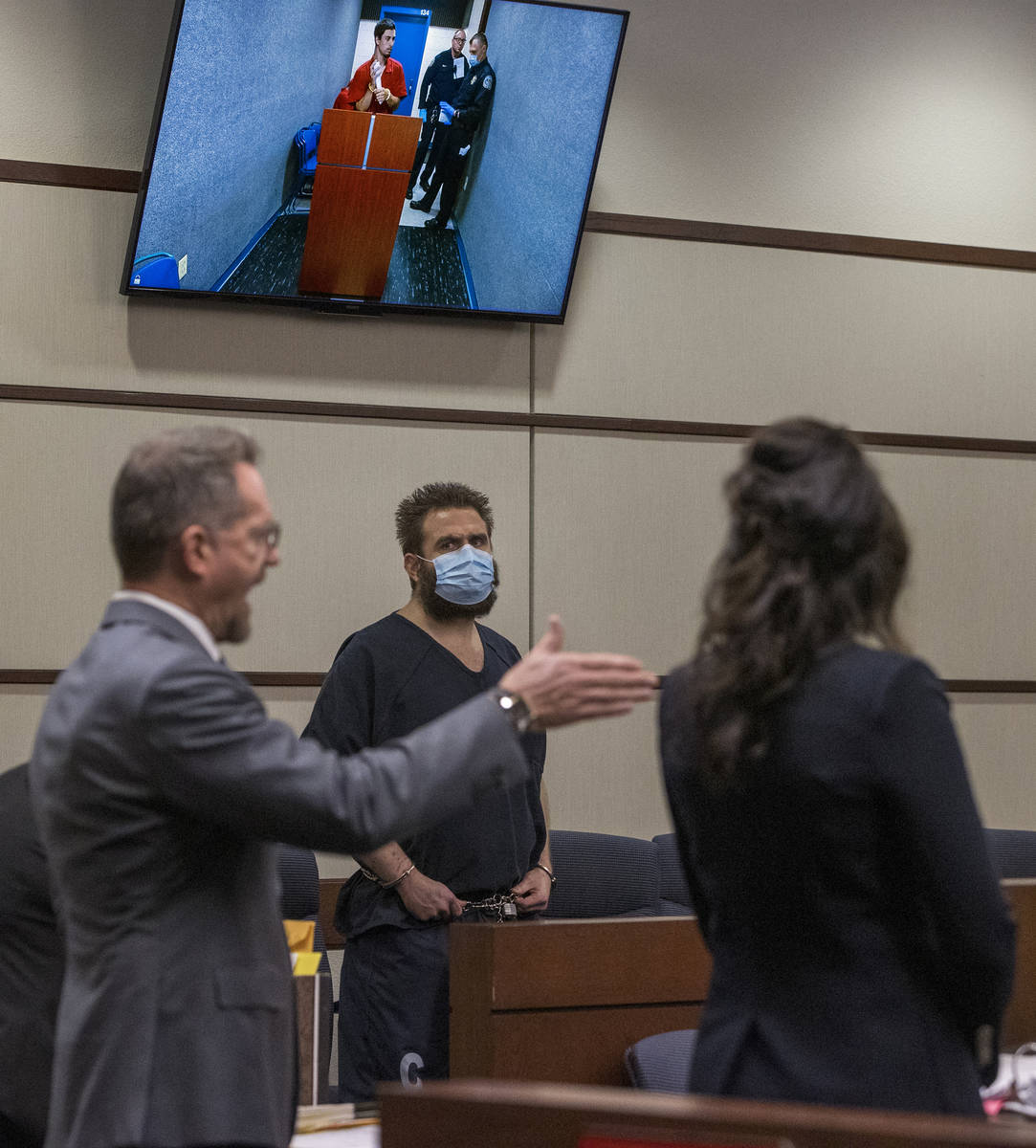 Joshua Nichols, center, listens to his lawyer Robert Draskovich during his court hearing with c ...