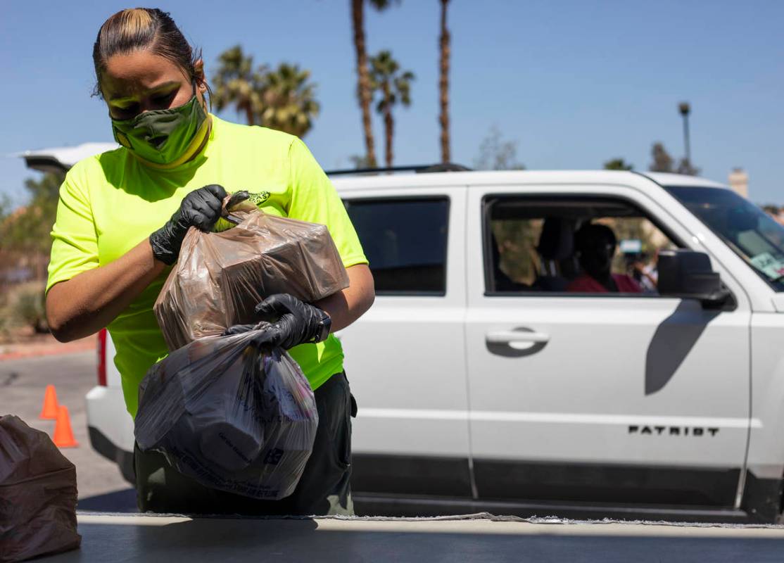 Naveld Amigon, a staff member at the Las Vegas Council of the Boy Scouts, begins to sort a dona ...