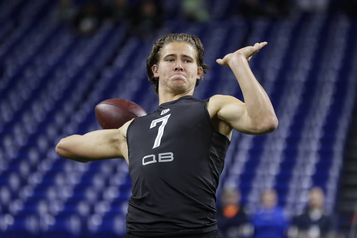 FILE - In this Feb. 27, 2020, file photo, Oregon quarterback Justin Herbert runs a drill at the ...