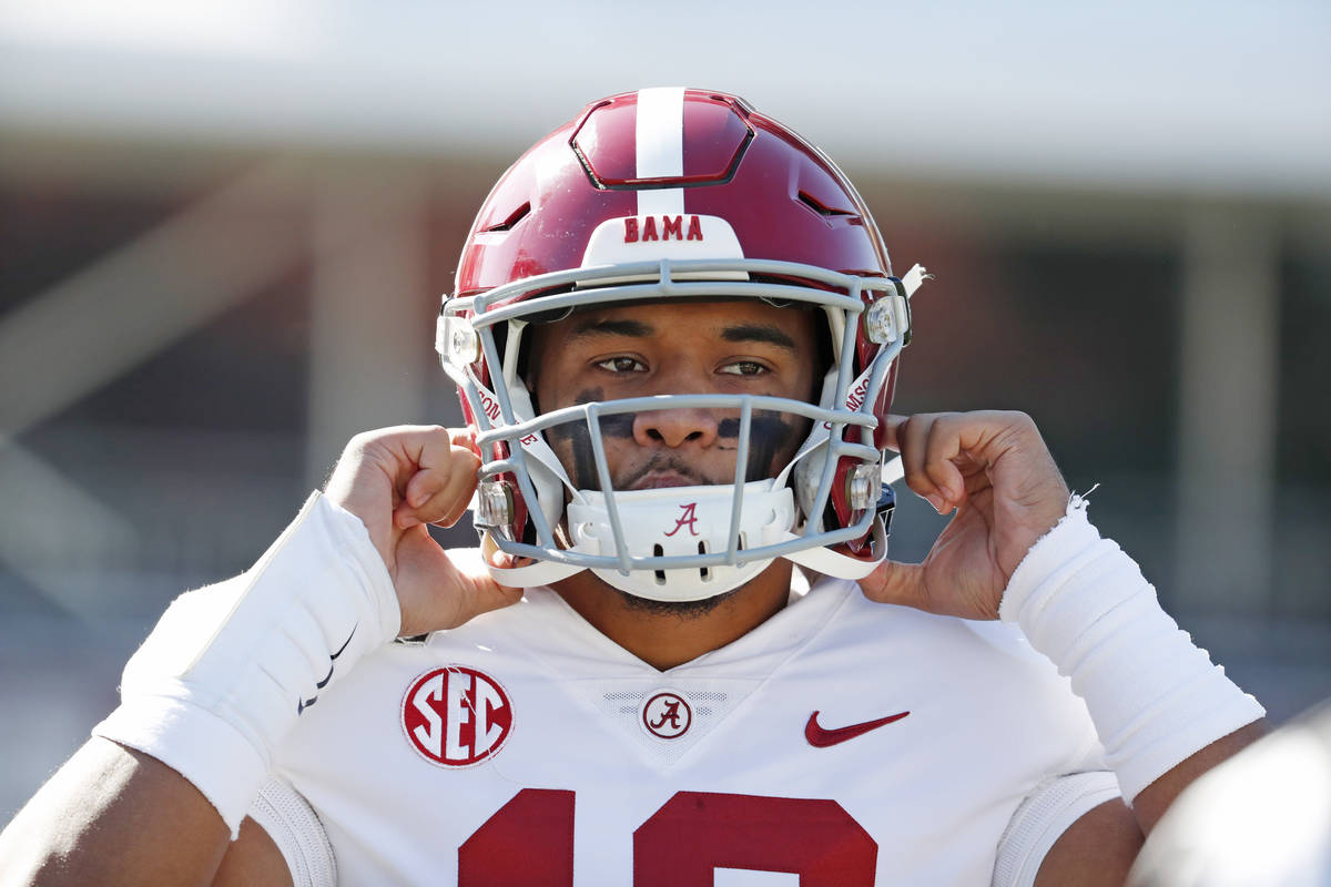 FILE - In this Nov. 16, 2019, file photo, Alabama quarterback Tua Tagovailoa (13) adjusts his h ...