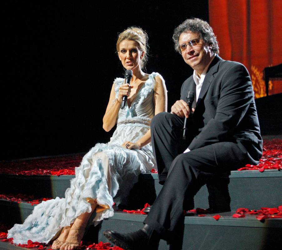 Celine Dion answers questions during a press conference as Franco Dragone looks on following th ...