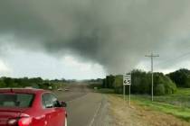 This image made from video provided by Thomas Marcum shows a tornado seen from State Highway 48 ...