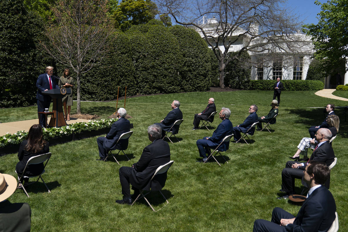 President Donald Trump and first lady Melania Trump participate in a tree planting ceremony to ...