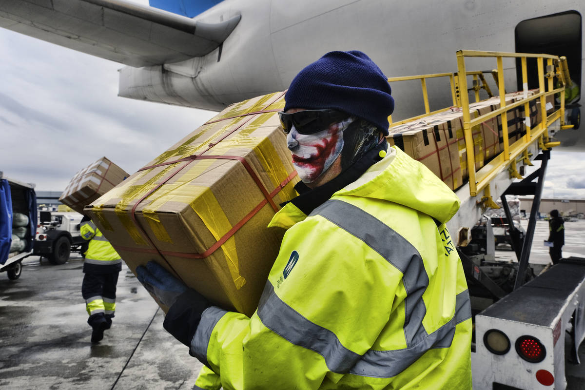 In an April 10, 2020, file photo, wearing protective masks ground crew at the Los Angeles Inter ...