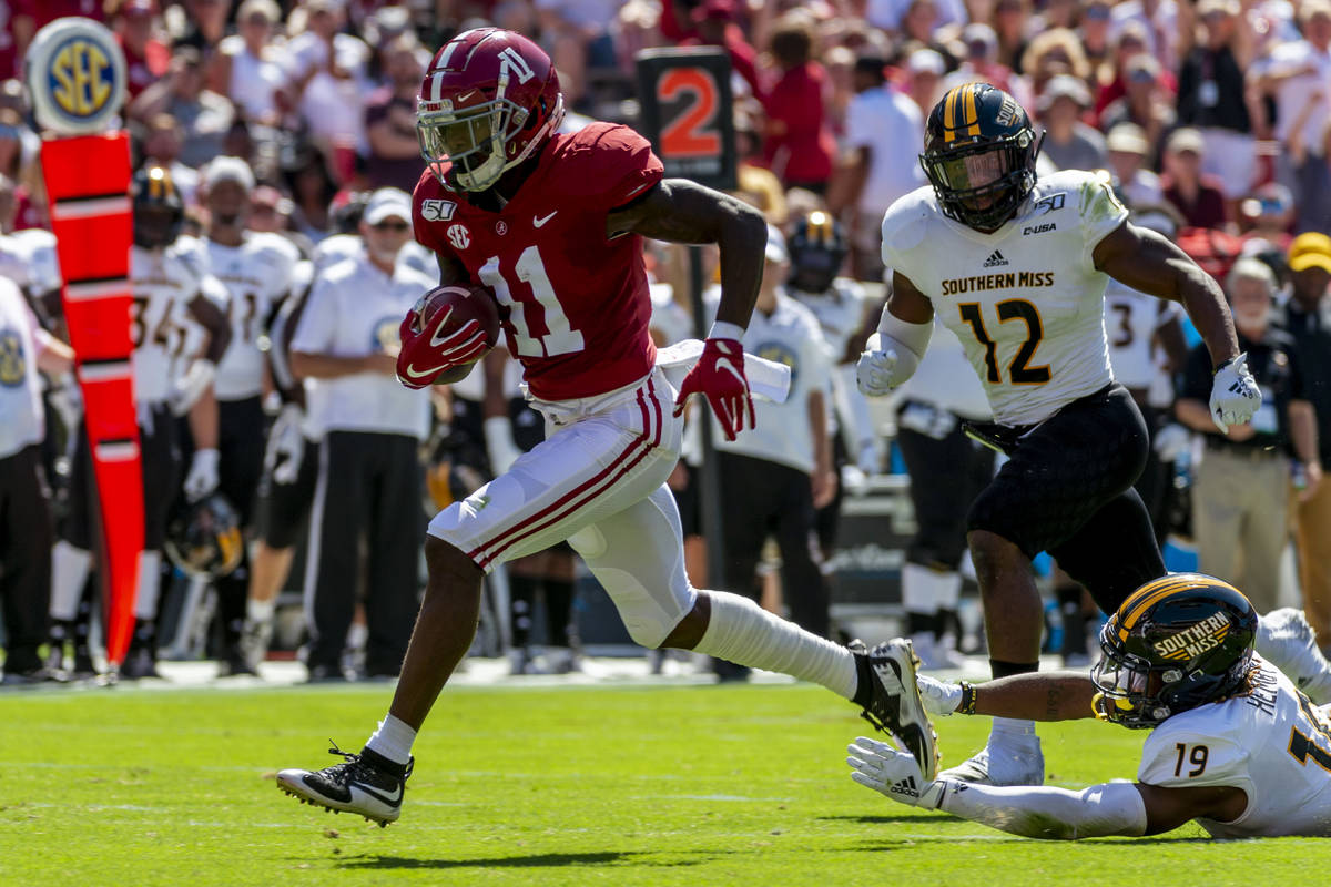 FILE - In this Sept. 21, 2019, file photo, Alabama wide receiver Henry Ruggs (11) runs in for a ...