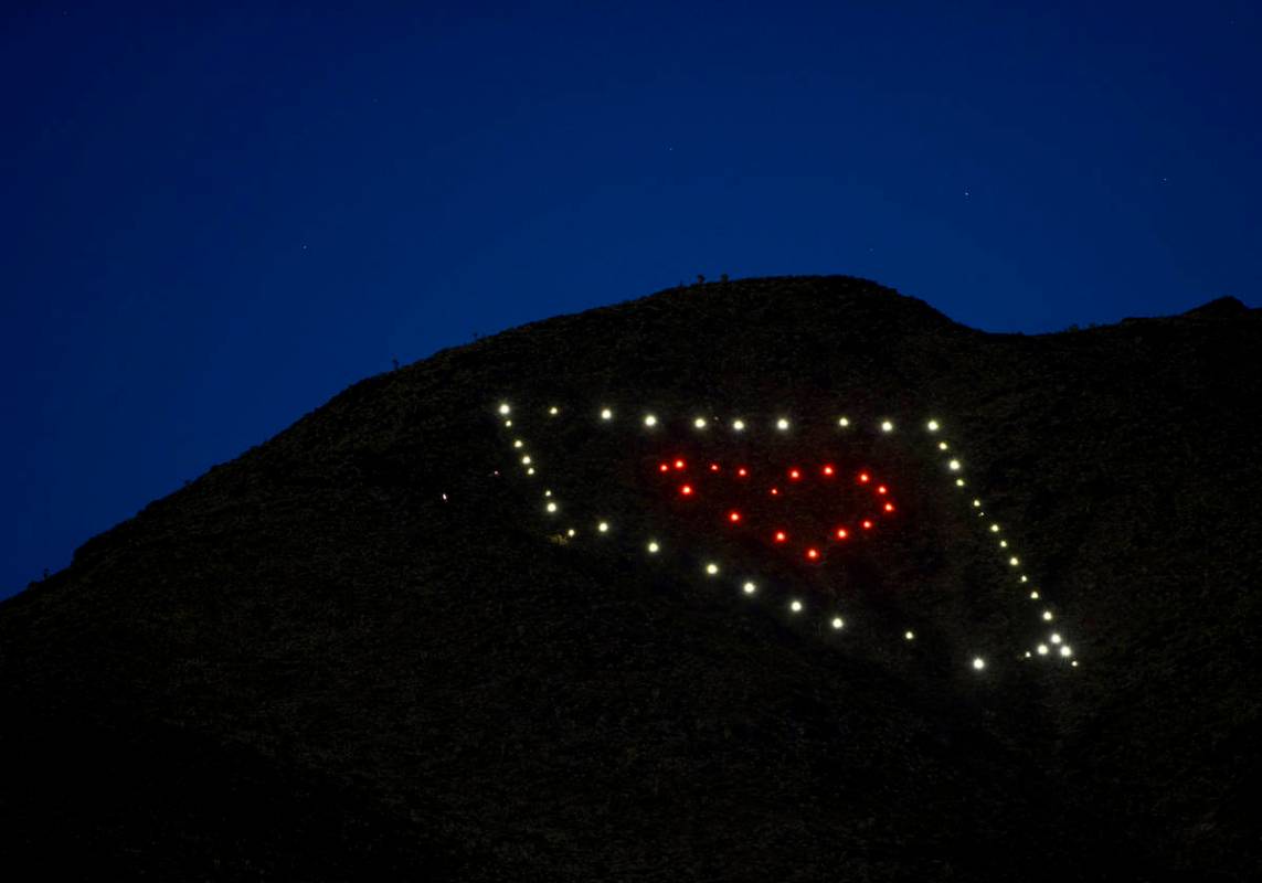 The solar lights come on at dusk from a Nevada light display atop of Black Mountain created by ...