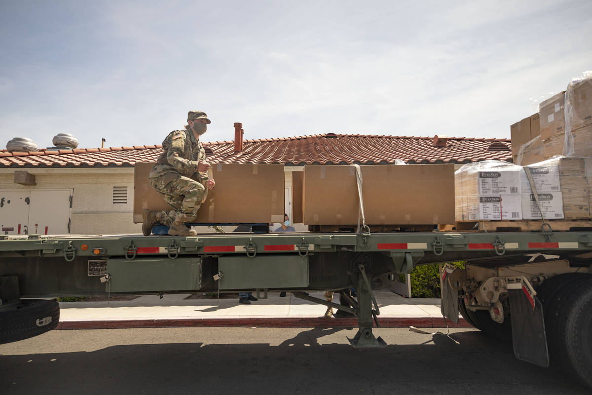 Nevada National Guard Sgt. Vanessa Gonzales unloads boxes of personal protective equipment to S ...