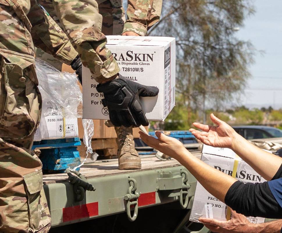 The Nevada National Guard unloads boxes of personal protective equipment to Silver Hills Health ...