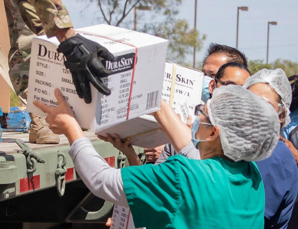 Staff of Silver Hills Health Care Center help unload boxes of personal protective equipment fro ...