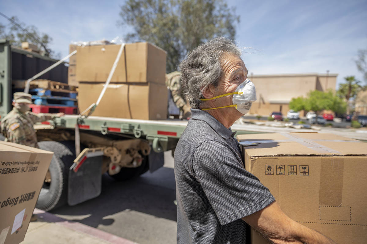 Housekeeping staff of Silver Hills Health Care Center Ampello Casillas smiles while helping unl ...