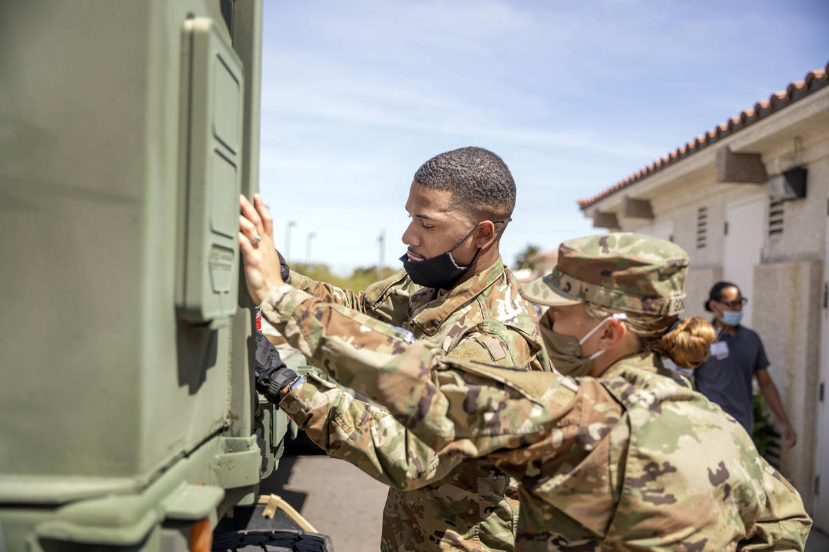 Nevada National Guard Spc.Donshay Watkins, left, and Sgt. Vanessa Gonzales unload personal prot ...