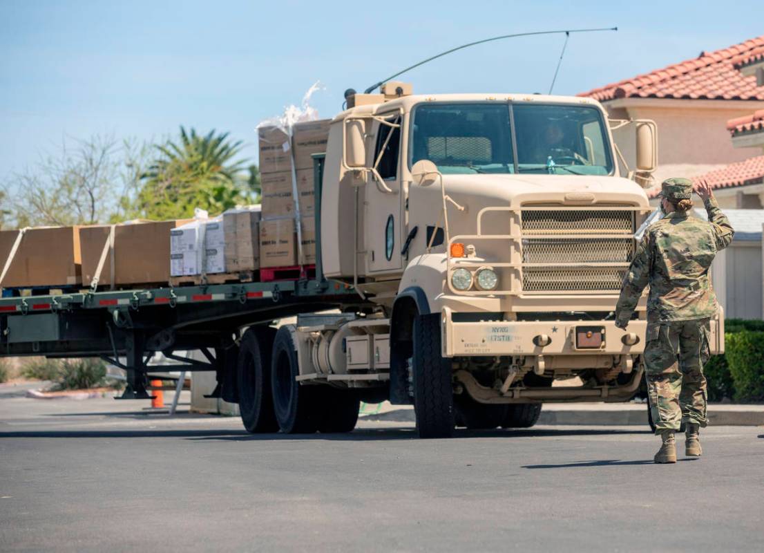 Nevada National Guard Sgt. Vanessa Gonzales directs a load of personal protective equipment arr ...