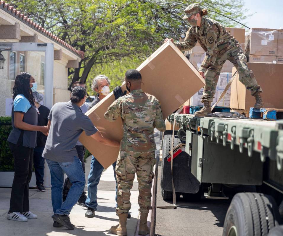 The Nevada National Guard unloads boxes of personal protective equipment to Silver Hills Health ...