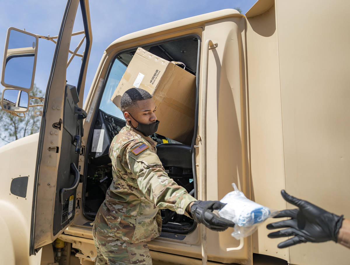 Nevada National Guard Spc. Donshay Watkins hands extra surgical masks to staff of Silver Hills ...