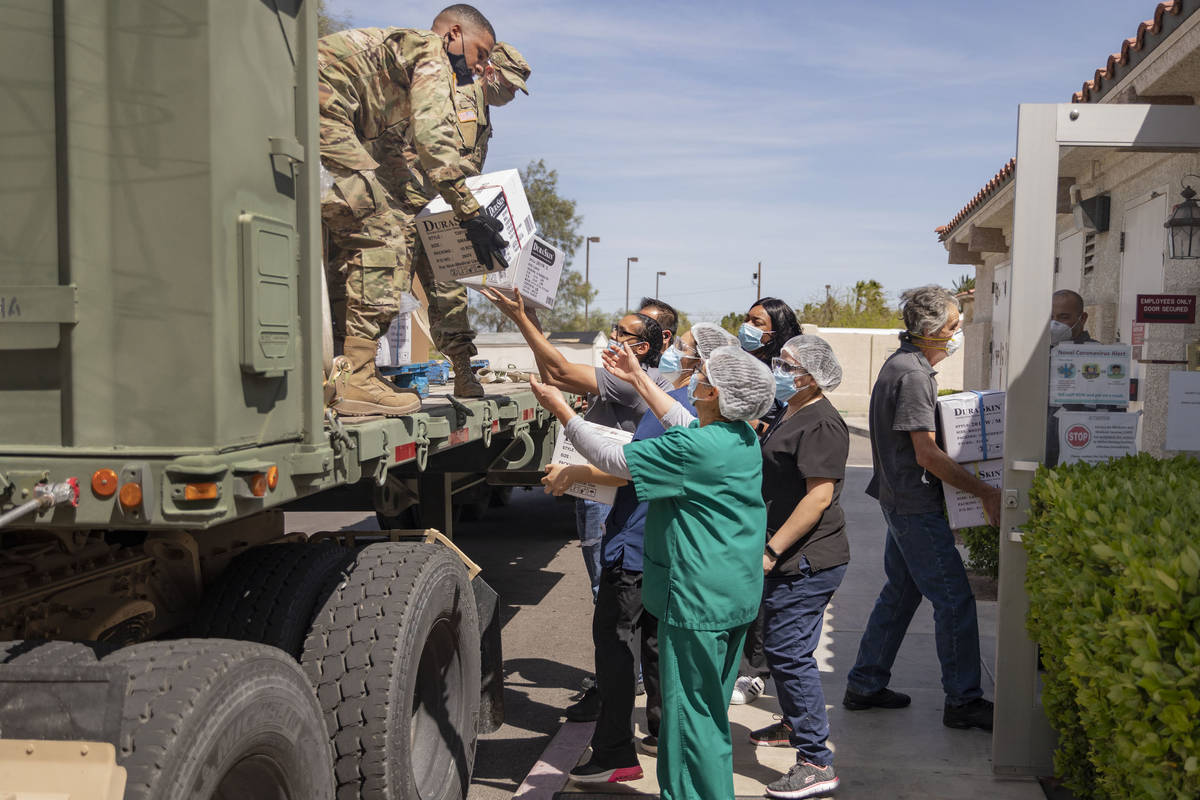 The Nevada National Guard unloads boxes of personal protective equipment to Silver Hills Health ...