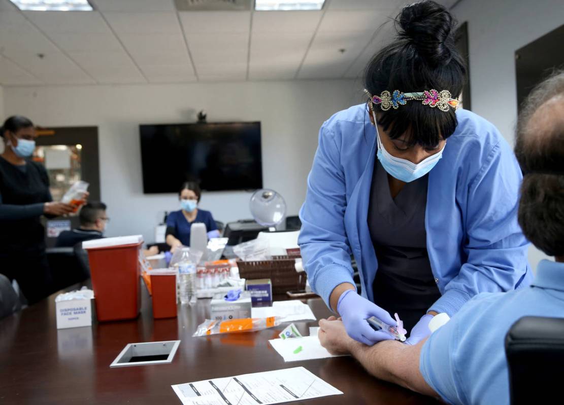 Phlebotomist Dana Duncan, 37, does voluntary COVID-19 antibody testing for an unidentified Desi ...