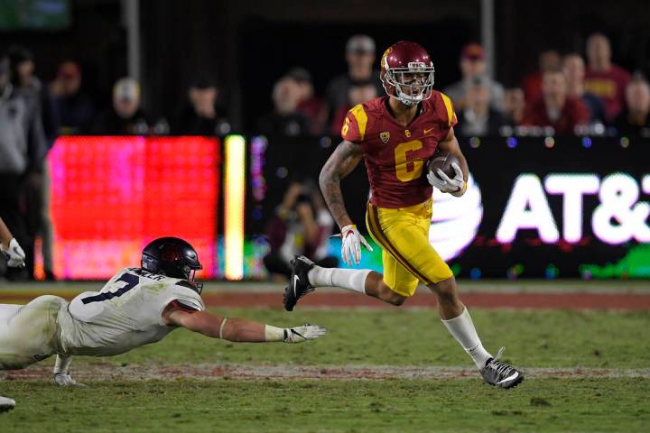 Southern California wide receiver Michael Pittman Jr., right, runs a ball as Arizona linebacker ...