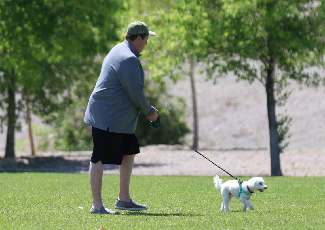 Jim Caranby of Henderson walks with his dog, Marshmello, at Cornerstone Park on Wednesday, Apri ...