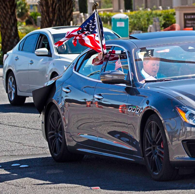 Wayne Allyn Root, sitting in the front passenger seat of a Maserati, leads a "caravan&quot ...