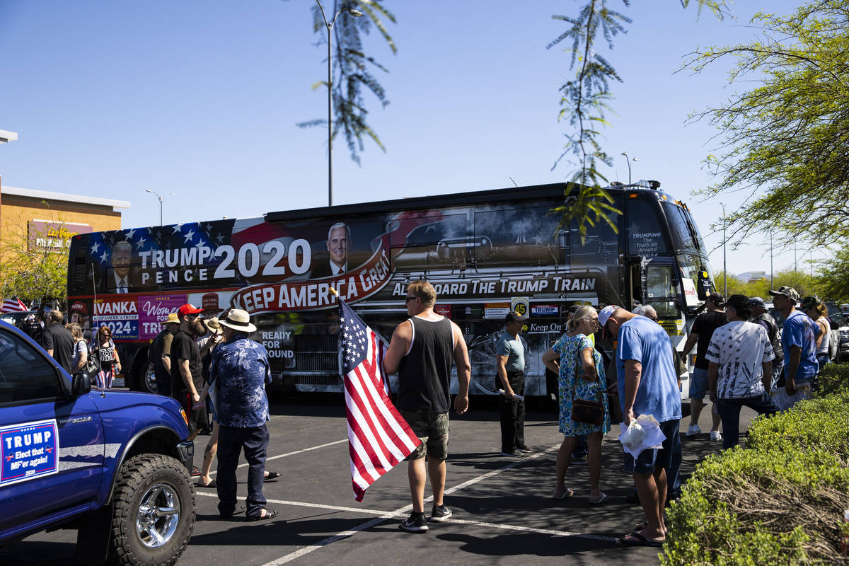 People gather at the Las Vegas South Premium Outlets before participating in a "caravan&qu ...