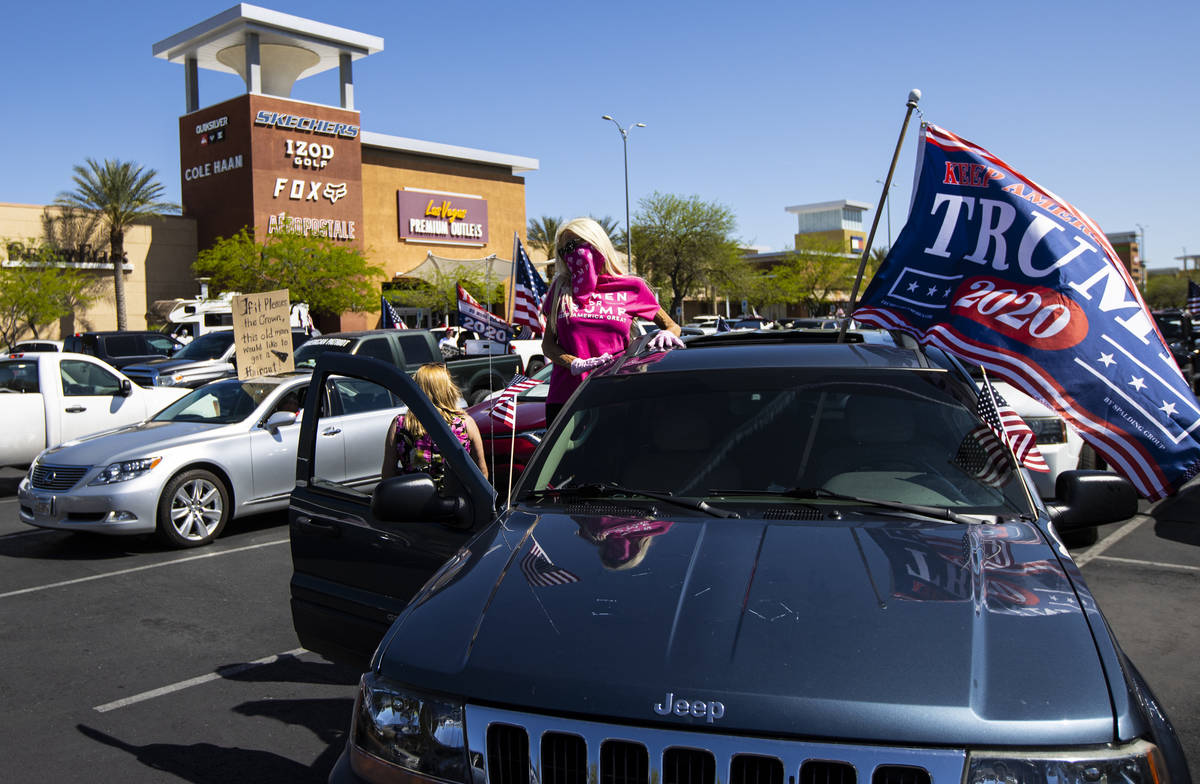 People gather at the Las Vegas South Premium Outlets before participating in a "caravan&qu ...