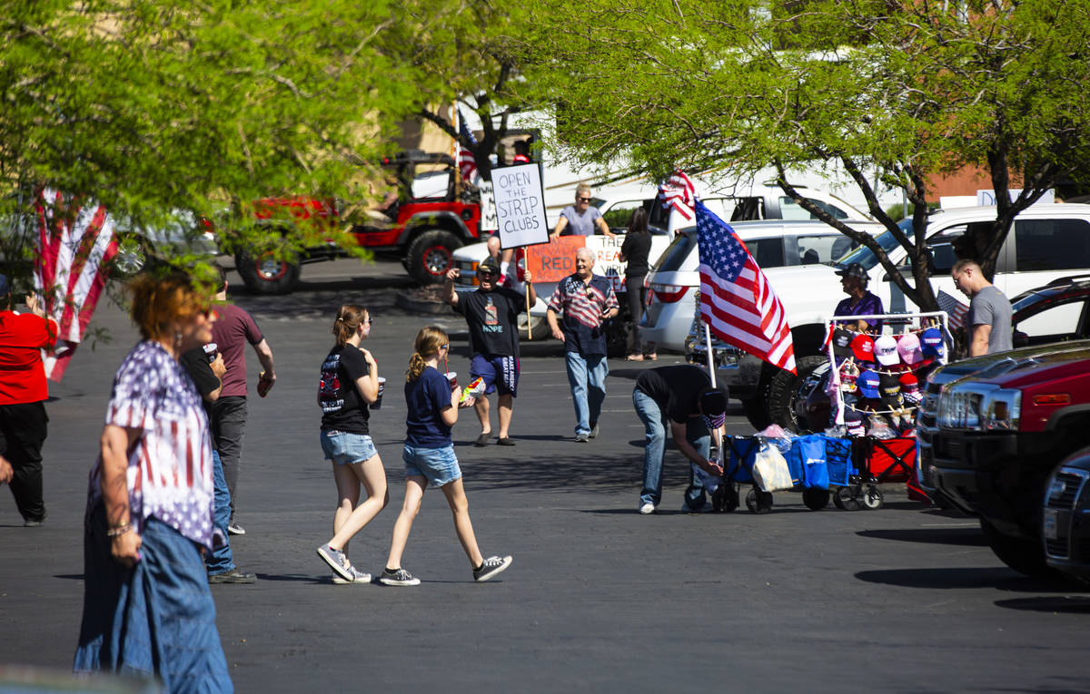 People gather at the Las Vegas South Premium Outlets before participating in a "caravan&qu ...