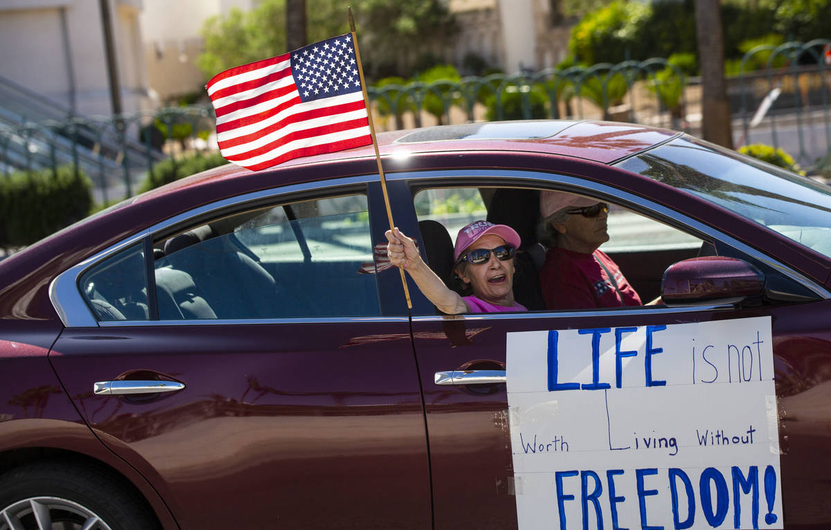 People participate in a "caravan" protest led by Wayne Allyn Root, not pictured, alon ...