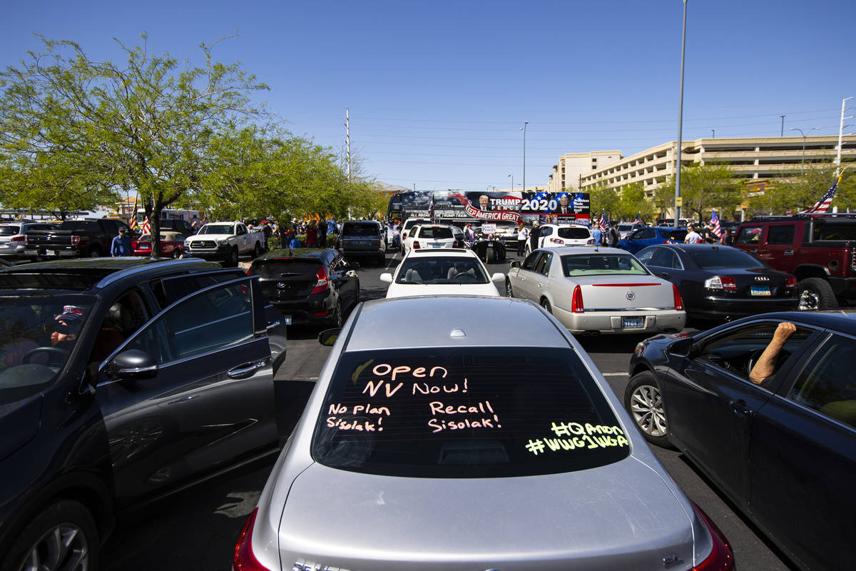 People gather at the Las Vegas South Premium Outlets before participating in a "caravan&qu ...