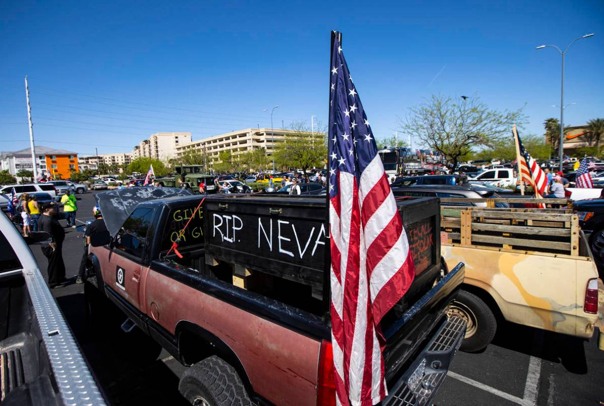 People gather at the Las Vegas South Premium Outlets before participating in a "caravan&qu ...