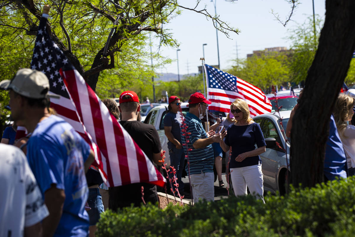 People gather at the Las Vegas South Premium Outlets before participating in a "caravan&qu ...