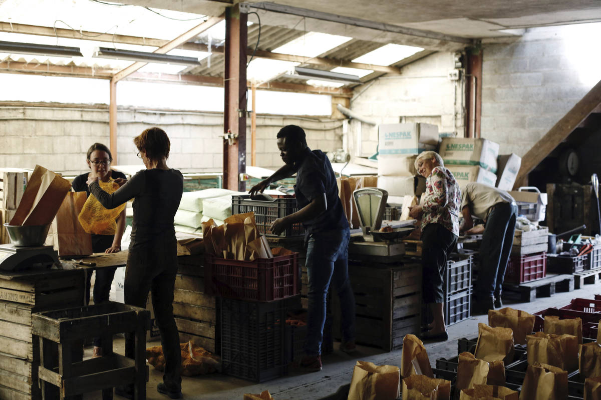 Workers prepare vegetables and fruits baskets, in Groslay, north of Paris, during nationwide co ...