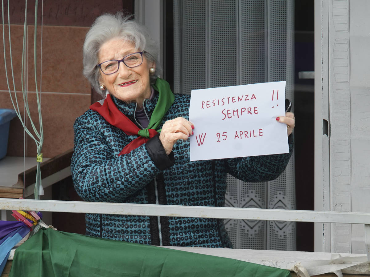 Former partisan Teresa Vergalli, 93, nicknamed Annuska, holds a note reading in Italian "R ...