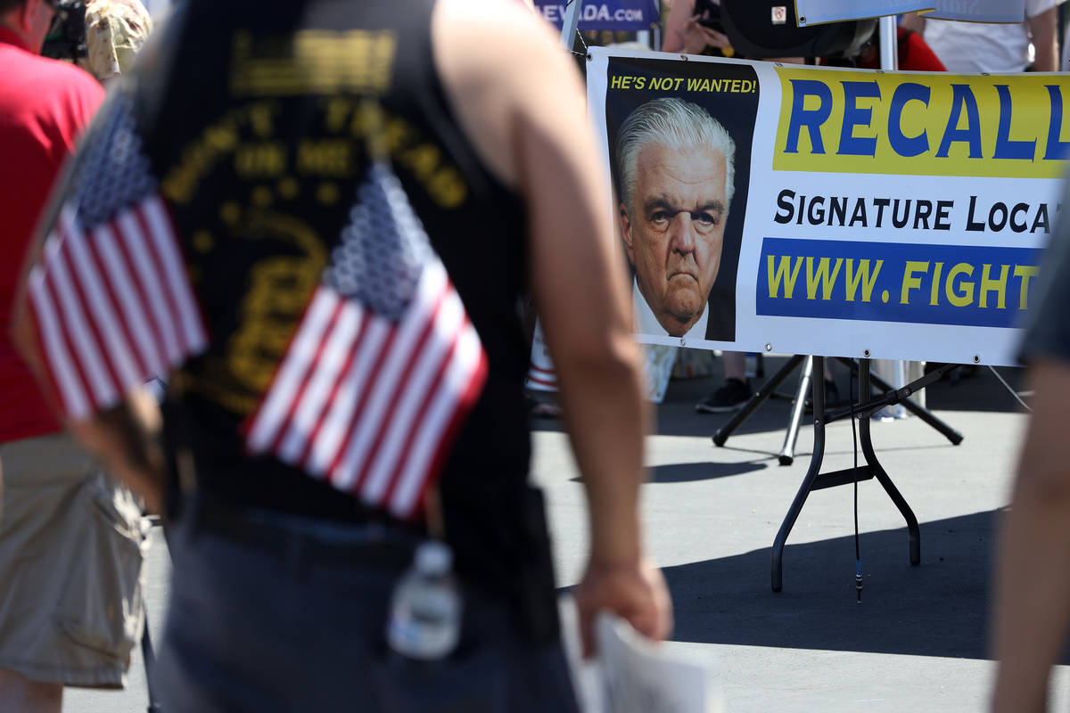 A sign shows Gov. Steve Sisolak with a message for a recall during a Fight For Nevada rally out ...