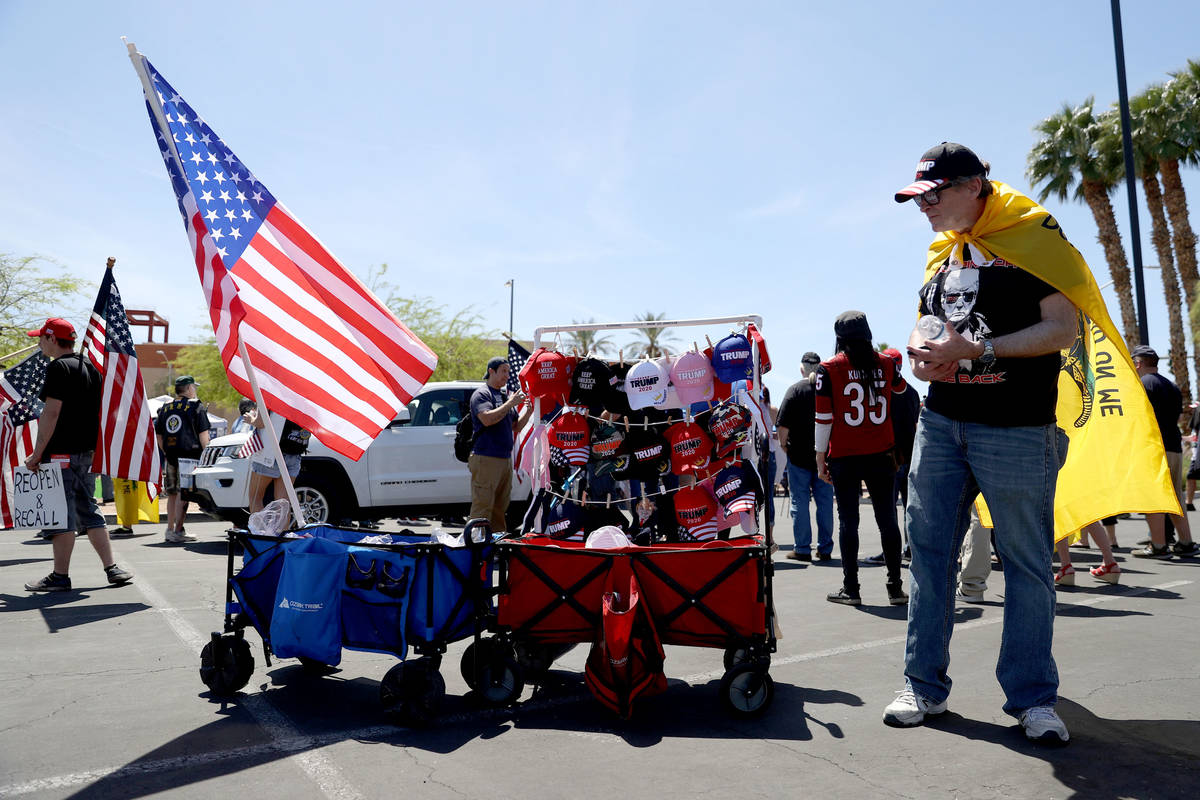 Ronald Solomon of Las Vegas sells merchandise during a Fight For Nevada rally outside of the Gr ...