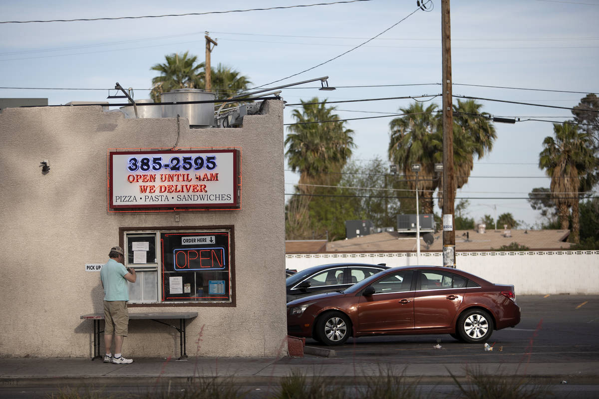 A customer waits for his order at Boston Pizza on Las Vegas Boulevard on Saturday, April 25, 20 ...