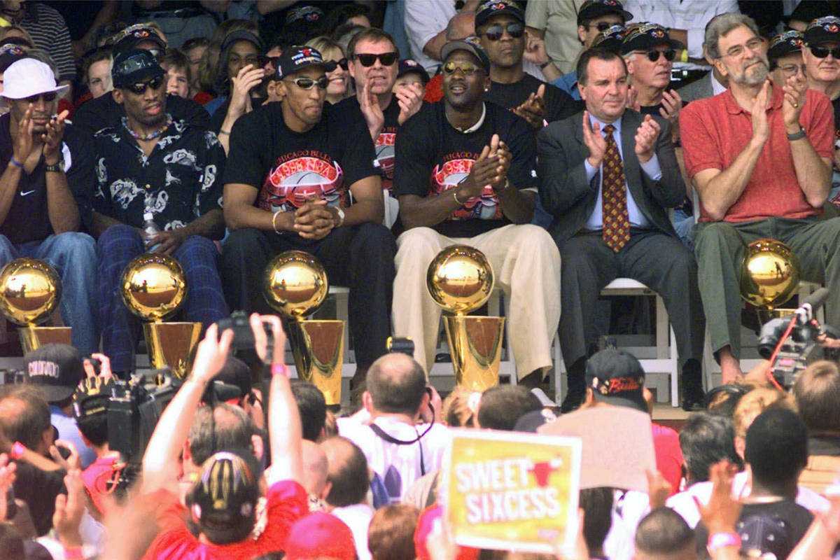 FILE - In this June 16, 1998, file photo, NBA Champions, from left: Ron Harper, Dennis Rodman, ...