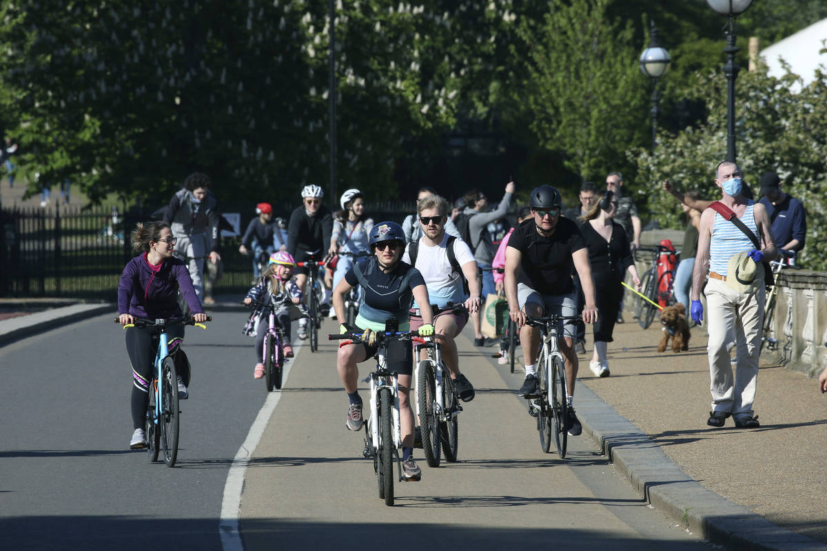Cyclists cross the Serpentine Bridge in Hyde Park as the UK continues its lockdown to help curb ...