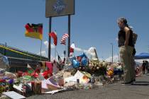 In this Aug. 12, 2019, photo, mourners visit the makeshift memorial near the Walmart in El Paso ...