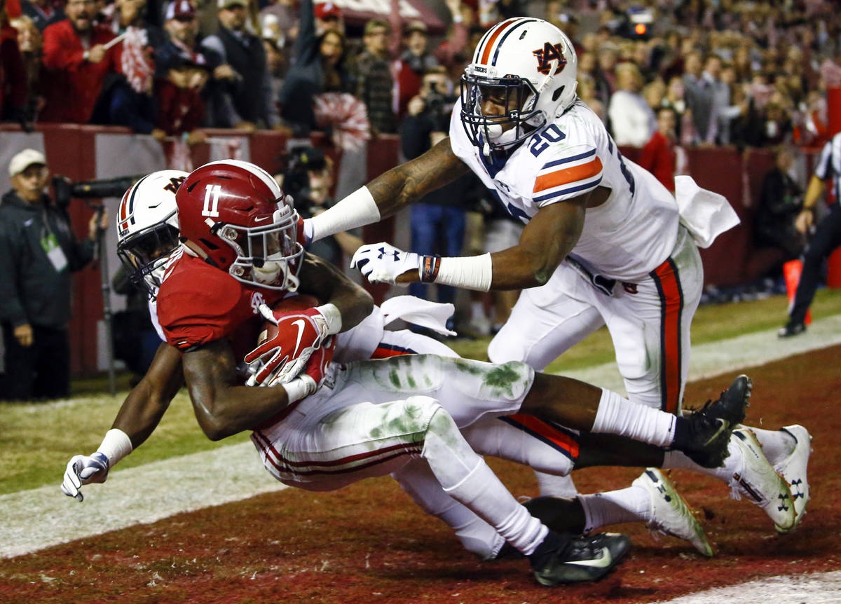 FILE - In this Nov. 24, 2018, file photo, Alabama wide receiver Henry Ruggs III (11) catches a ...